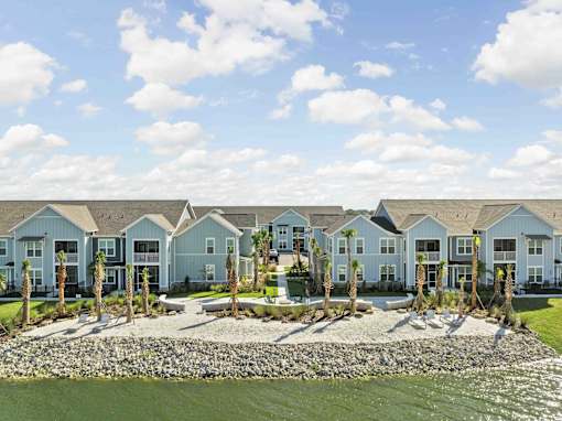 A row of houses with a body of water in front. at Junction Apartments in Rockledge, FL