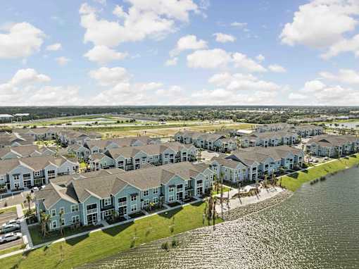 A row of houses with a body of water in front. at Junction Apartments in Rockledge, FL