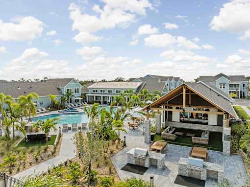 A large house with a pool and a patio area. at Junction Apartments in Rockledge, FL