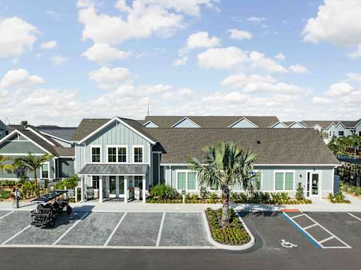 A building with a parking lot in front of it. at Junction Apartments in Rockledge, FL