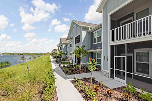 A row of houses with a walkway in between. at Junction Apartments in Rockledge, FL