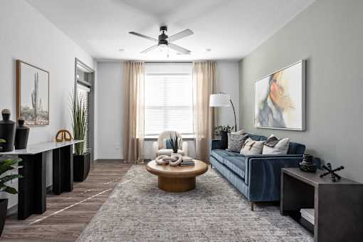 A living room with a blue couch and a coffee table.