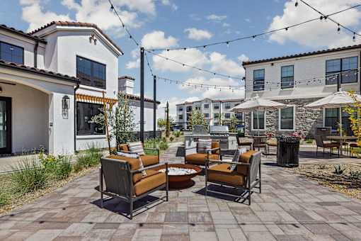 A patio with a table and chairs is surrounded by houses.at Stella, San Tan Valley Arizona