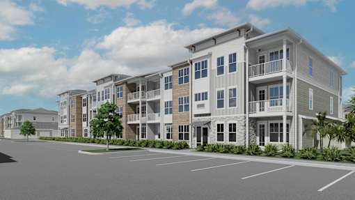 A row of modern apartment buildings with a parking lot in front at Verity Luxury Apartment Homes Apartments, Vero Beach