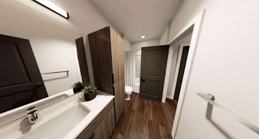 A modern bathroom with a white sink and brown cabinetry at Stack at Wheat Ridge Apartments, Apartments, Wheat Ridge, CO