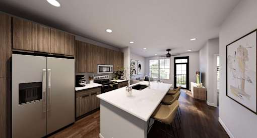 A modern kitchen with a large island and stainless steel appliances at Stack at Wheat Ridge Apartments, Wheat Ridge