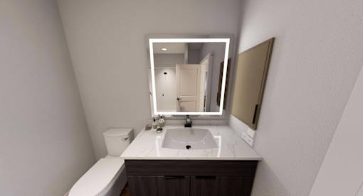 A bathroom with a sink, mirror, and toilet at Stack at Wheat Ridge Apartments, Colorado, 80033