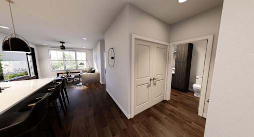 A modern kitchen with a dining table and chairs at Stack at Wheat Ridge Apartments, Colorado
