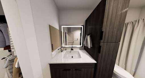 A bathroom with a sink, mirror, and towel rack at Stack at Wheat Ridge Apartments, Wheat Ridge, CO, 80033