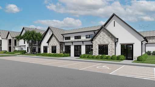 A modern building with a parking lot in front at The Levi Luxury Apartments, McDonough, Georgia