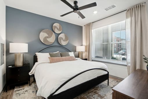 a bedroom with a bed and a ceiling fan at The Maddox Luxury Apartment Homes, Arizona  