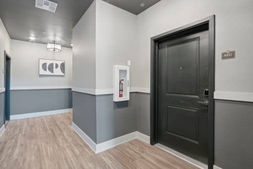 a hallway with a black door at The Maddox Luxury Apartment Homes, Buckeye, AZ 85326  