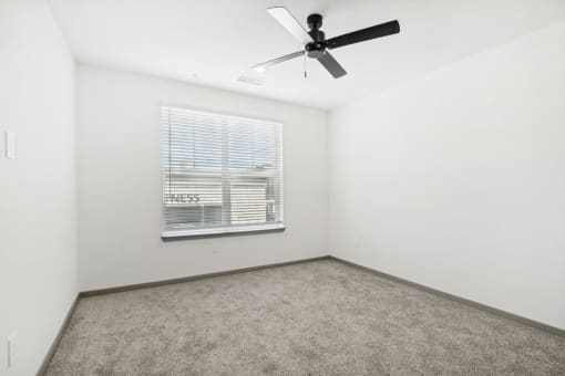 a room with a ceiling fan and a window at The Maddox Luxury Apartment Homes, Buckeye  