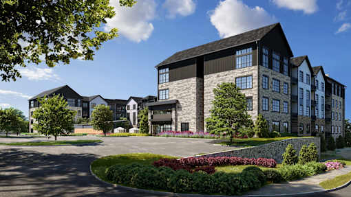 A modern building with a large front yard and a curved driveway.