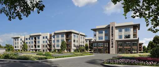 A modern apartment complex with a landscaped entrance.