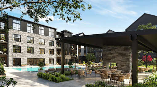 A modern building with a pool and outdoor seating area.