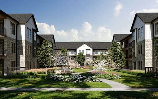 A row of houses with a garden in front.