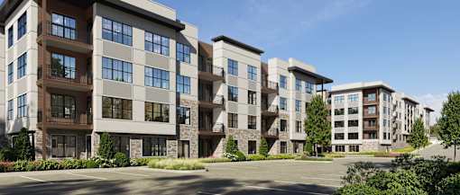 A row of modern apartment buildings with balconies and large windows.