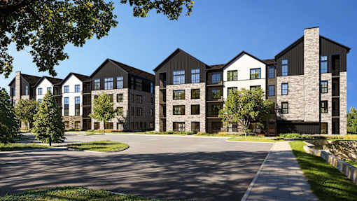 A large, modern building with a mix of black and beige exterior walls.