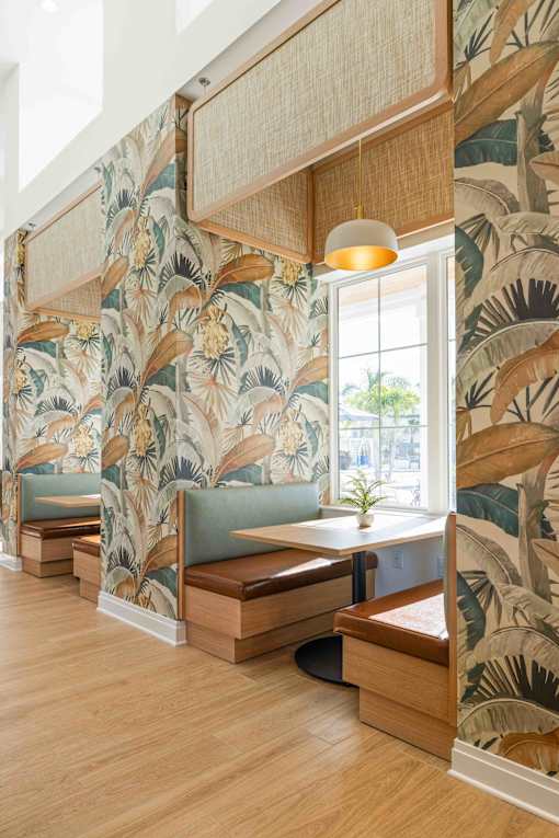 A room with a wallpapered wall and a wooden bench at Verity Luxury Apartments, Vero Beach