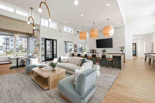 A living room with a grey sofa and a wooden coffee table at Verity Luxury Apartments, Vero Beach