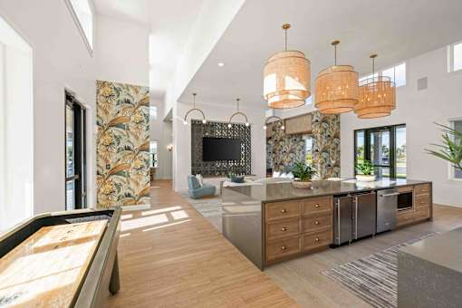 A modern kitchen with a pool table in the middle at Verity Luxury Apartments, Florida