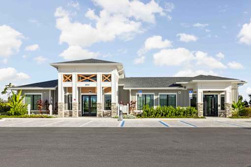A building with a parking lot in front of it at Verity Luxury Apartments, Vero Beach, Florida