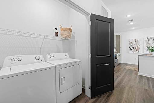 A black door is in the middle of a white wall at Verity Luxury Apartments, Vero Beach, 32960