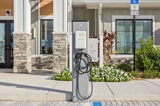 A charging station for electric vehicles is located outside a building at Verity Luxury Apartments, Vero Beach, 32960