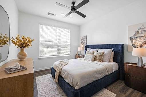 A bedroom with a large bed and a ceiling fan at Verity Luxury Apartments, Vero Beach, 32960