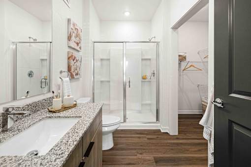A bathroom with a white sink and a walk-in shower at Verity Luxury Apartments, Vero Beach, Florida