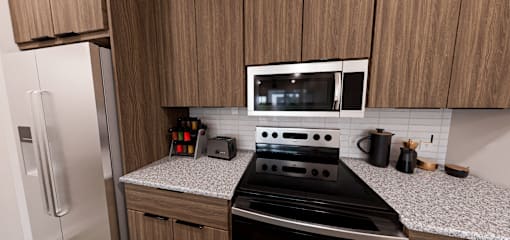 A kitchen with a black stove top oven and a microwave above it at Verity Luxury Apartment Homes Apartments, Vero Beach, Florida