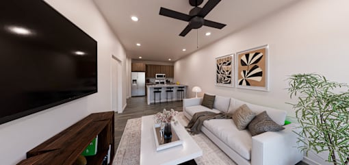 A modern living room with a white couch and a large flat screen TV mounted on the wall at Verity Luxury Apartment Homes Apartments, Florida, 32960