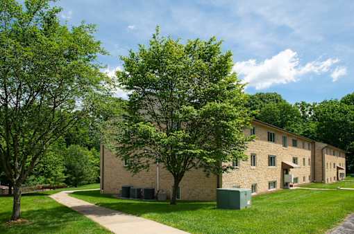 A large building with a green lawn in front of it.