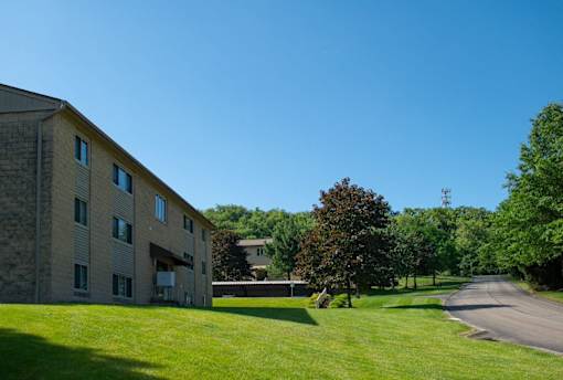 A large building with a green lawn in front of it.