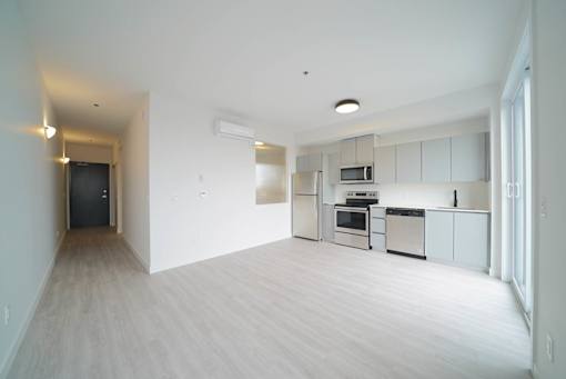 Kitchen and Living Area With Modern Finishings at 703 St. Anne's Road Apartments, Winnipeg, MB