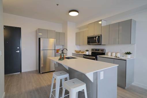 Modern Kitchen With Bar Counter at 703 St. Anne's Road Apartments, Winnipeg, MB