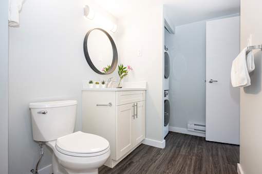 a white bathroom with a toilet and a sink