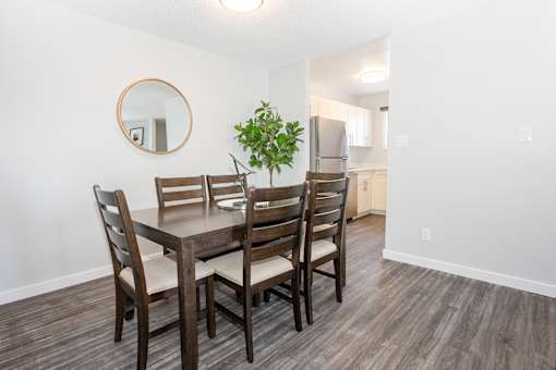 a dining room with a table and chairs and a kitchen