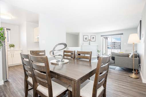 a dining room with a wooden table and chairs