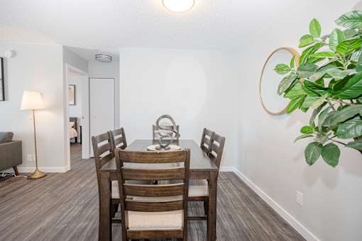 a dining room with a wooden table and chairs