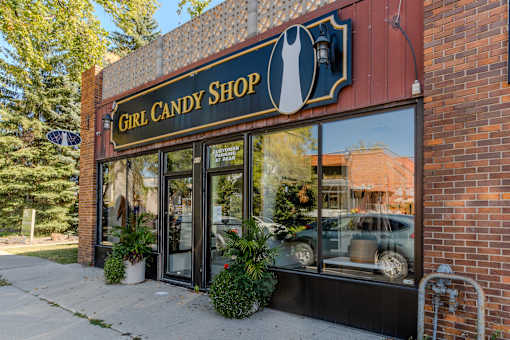 the front of a building with a sign that reads girl candy shop