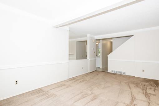 A room with a wooden floor and white walls.