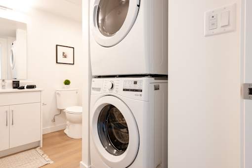 A white washing machine in a laundry room.