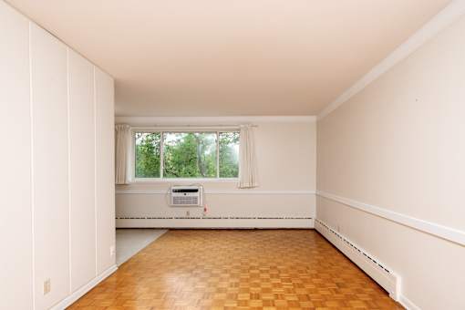 A room with a window and a radiator on the wall.