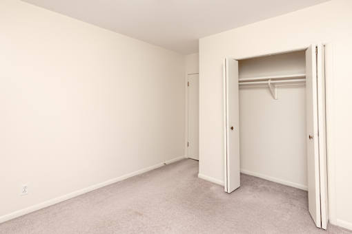 A white room with a doorway leading to another room.