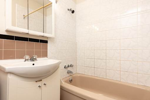 A white sink is on a cabinet in a bathroom.