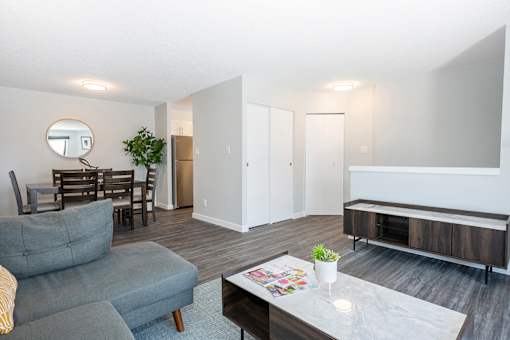 a living room and dining room with a couch and a table