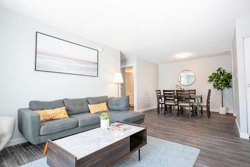 a living room and dining room with a couch and a table