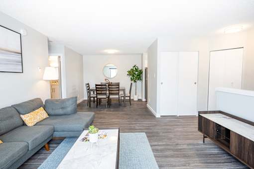 a living room with a couch and a dining room table